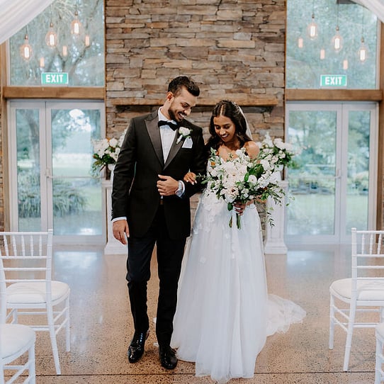 Bride and Groom infront of Stone Fireplace