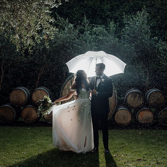 Bride and Groom infront of Barrel Feature