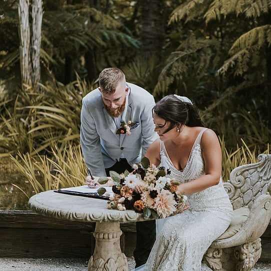 Couple Signing Marriage Certificate at their Barrel Waterfall Wedding Ceremony