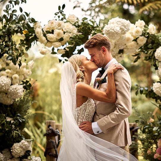 Couple Kissing at their Barrel Waterfall Wedding Ceremony