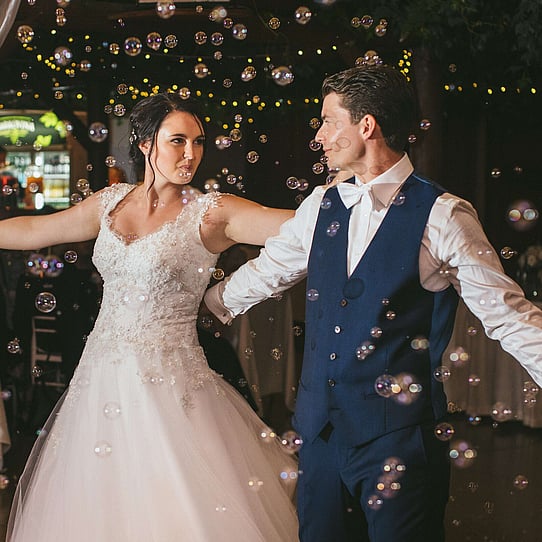 Bride 7 Groom Dancing with Bubbles Dropping