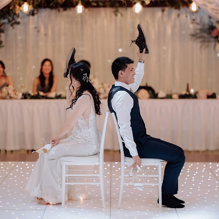 Bride and Groom Playing Shoe Game