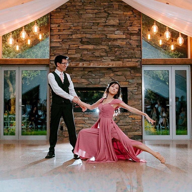 Bride and Groom Dancing infront of Stone Fireplace