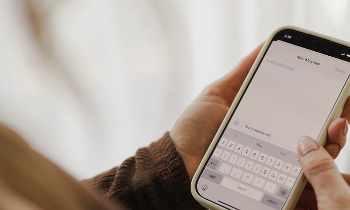 Mobile phone with the message saying "You're approved"