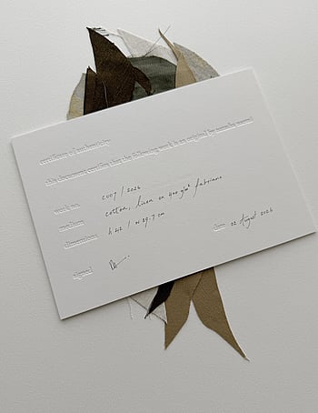 image of natasha naomi studio certificate of authenticity resting on top of c007 / 2026 in preparation to package and send to its new owner