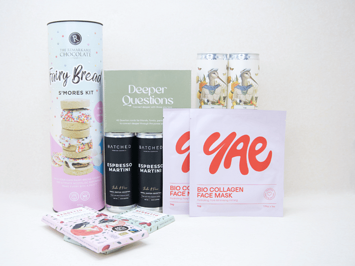 Good Times Gift Box featuring Uncommon sparkling wine, espresso martinis, Deeper Questions card game, YAE collagen face masks, Remarkable S'mores kit, and Bennetto chocolates, beautifully packaged for birthdays, girls' nights, date nights, and shared experiences.