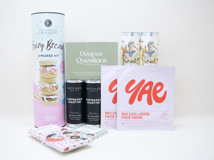 Good Times Gift Box featuring Uncommon sparkling wine, espresso martinis, Deeper Questions card game, YAE collagen face masks, Remarkable S'mores kit, and Bennetto chocolates, beautifully packaged for birthdays, girls' nights, date nights, and shared experiences.