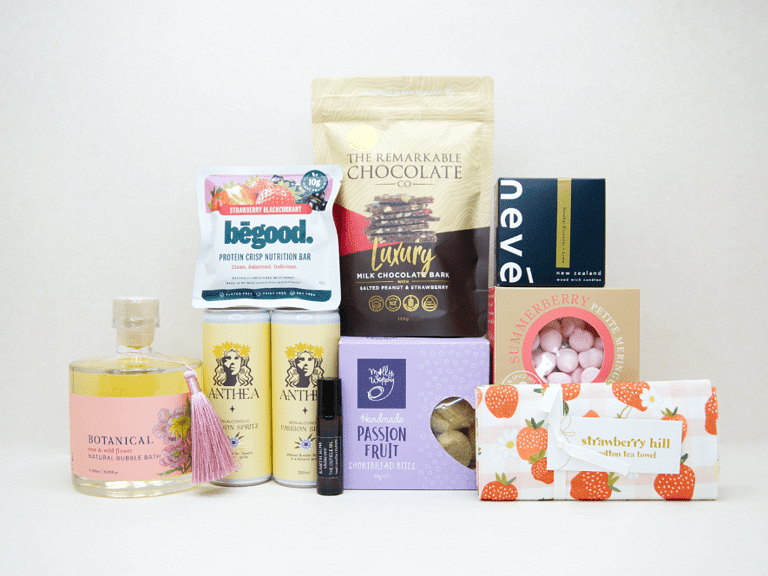 Celebrate The New Mum Gift Box featuring Anthea alcohol-free sparkling wine, Lily & George teddy bear, So Loved baby book, Becca Project candle, Botanicals bath bombs, artisan chocolate, and nourishing treats, beautifully packaged for new mums and new babies.