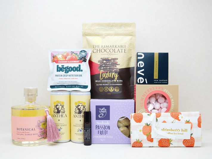 Just For Her Gift Box featuring Anthea Passionfruit Spritz, Neve candle, Botanicals bubble bath, Earthrowe cuticle oil, Strawberry Hill tea towel, Remarkable strawberry pretzel bark, Molly Woppy Passionfruit Cookies, strawberry meringues, and a Be Good protein bar, beautifully packaged for gifting, celebration, and self-care.