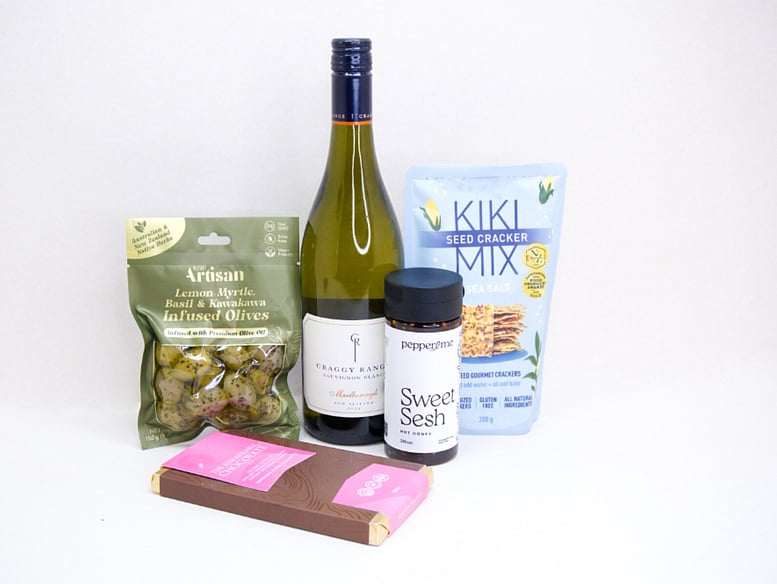 Wine & Crackers Gift Box featuring Craggy Range Sauvignon Blanc, artisan olives, Kiki Seed Crackers, Pepper & Me Hot Honey, and Remarkable Raspberry Marshmallow Chocolate, beautifully packaged for wine lovers and gourmet gifting.