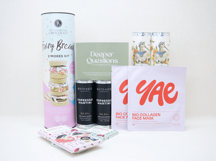 Good Times Gift Box featuring Uncommon sparkling wine, espresso martinis, Deeper Questions card game, YAE collagen face masks, Remarkable S'mores kit, and Bennetto chocolates, beautifully packaged for birthdays, girls' nights, date nights, and shared experiences.