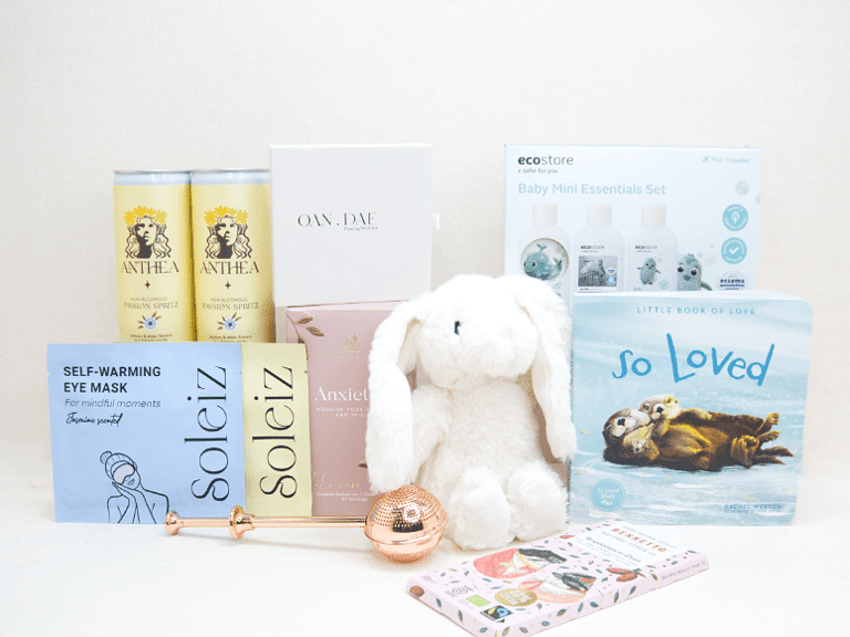 The New Chapter Gift Box featuring a bunny soft toy, baby memory book, OAN DAE Wish Kit, Soleiz eye masks, Anthea 0% Passionfruit Spritz, Anxiety Tea with tea infuser, Ecostore Mini Essentials Set, and a handwritten gift card, beautifully presented in a premium KYND gift box.