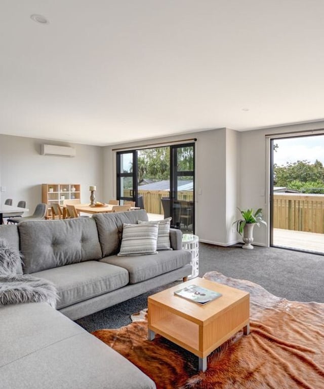Image of lounge looking out to a deck. Built by MJW Homes. Dunedin, Otago NZ