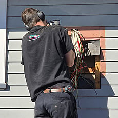 Alectrics electrician upgrading an outdoor residential switchboard in Hillcrest.