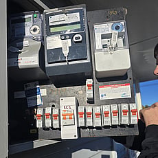 Old circuit breakers and electrical components inside the upgraded switchboard.