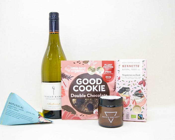 A Moment For You Gift Box featuring Craggy Range Sauvignon Blanc, a Becca Project candle, Botanicals foot soak, Little Bird Organics Good Cookie, and Bennetto raspberry chocolate, thoughtfully curated for relaxation, self-care, and everyday indulgence.