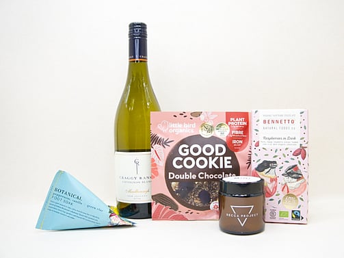 A Moment For You Gift Box featuring Craggy Range Sauvignon Blanc, a Becca Project candle, Botanicals foot soak, Little Bird Organics Good Cookie, and Bennetto raspberry chocolate, thoughtfully curated for relaxation, self-care, and everyday indulgence.