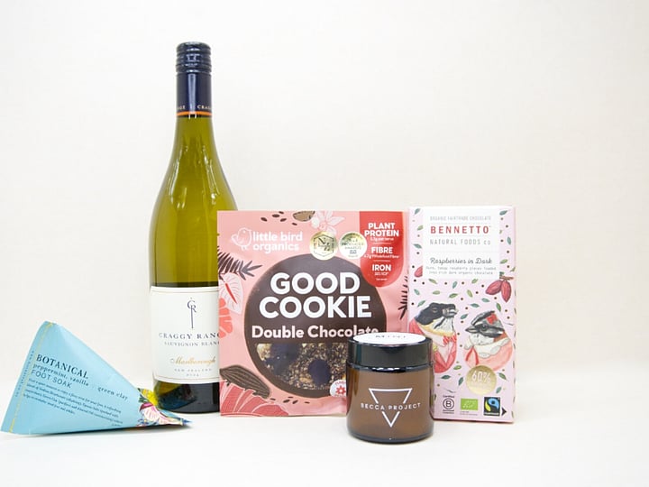 A Moment For You Gift Box featuring Craggy Range Sauvignon Blanc, a Becca Project candle, Botanicals foot soak, Little Bird Organics Good Cookie, and Bennetto raspberry chocolate, thoughtfully curated for relaxation, self-care, and everyday indulgence.