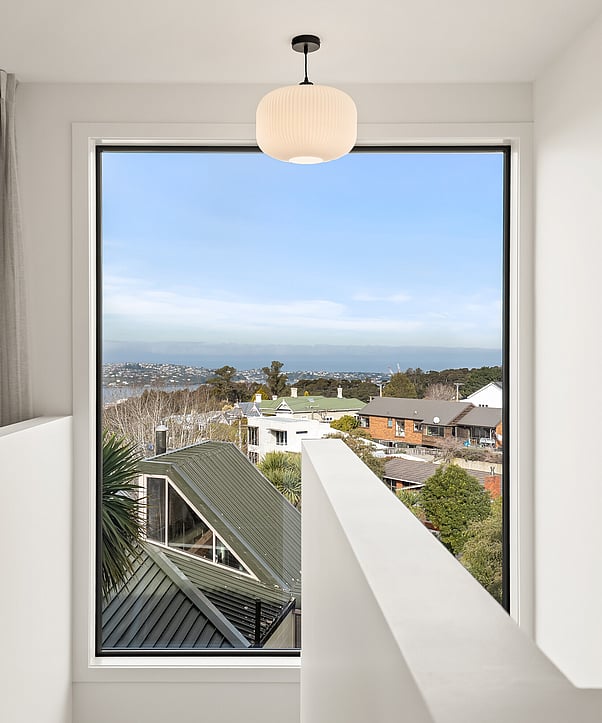 Image of contemporary stairwell with view at Hightridge Gate townhouse collection at Maori Hill by MJW Homes. Dunedin, Otago.