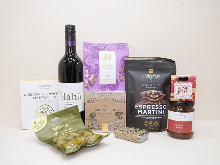 Gourmet Red Wine Hamper featuring Sileni Merlot, mulled wine spices, artisan olives, honeycomb, BiteMeat jerky, Pinot Noir jelly, espresso martini chocolate, cheddar and poppy seed wafers, festive relish, and Opito Bay salt, thoughtfully curated for entertaining, grazing, and wine lovers.