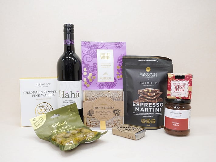 Gourmet Red Wine Hamper featuring Sileni Merlot, mulled wine spices, artisan olives, honeycomb, BiteMeat jerky, Pinot Noir jelly, espresso martini chocolate, cheddar and poppy seed wafers, festive relish, and Opito Bay salt, thoughtfully curated for entertaining, grazing, and wine lovers.