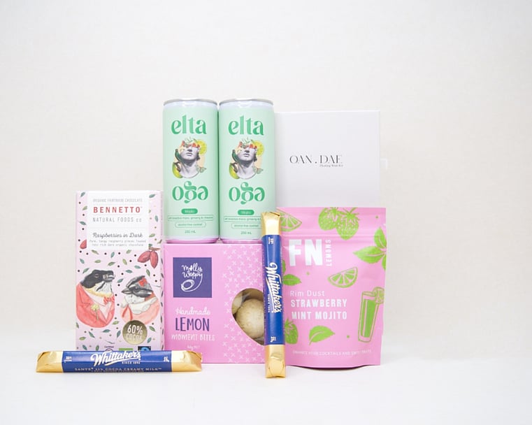 A Gentle Wish Gift Box featuring an OAN DAE Floating Wish Paper Kit, Elta Ego Alcohol Free Mojitos, Bennetto Raspberry Dark Chocolate, Whittaker's Sante Bars, Molly Woppy Lemon Moments, and FN Strawberry Mint Mojito Lemon Dust, thoughtfully curated for meaningful moments, connection, and making wishes.