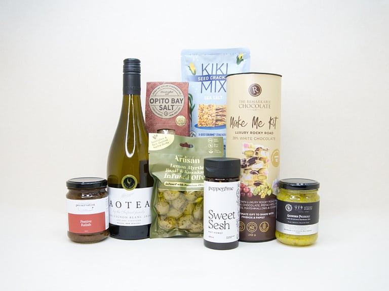 Food & Wine Hamper featuring Aotea Sauvignon Blanc, artisan olives with lemon myrtle and kawakawa, Kiki Seed Crackers, The Kitchen Window Piccalilli, Preservation Festive Chutney, Pepper & Me Hot Honey, Opito Bay Chilli Salt, and a Remarkables Rocky Road Kit, thoughtfully curated for entertaining, grazing, and gourmet gifting.