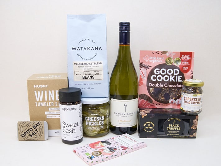 Corporate Gift Hamper featuring Craffy Range Sauvignon Blanc, Matakana Coffee Roasters coffee beans, a HUSKI wine tumbler, Opito Bay salt tin, Bennetto chocolate, PICKLED Sizzled Cucumbers, Rutherford & Meyer Black Truffle Wafer Crackers, a Little Bird Good Cookie, and a Superseed Salad Topper, thoughtfully curated for corporate gifting, client gifts, and settlement gifts.