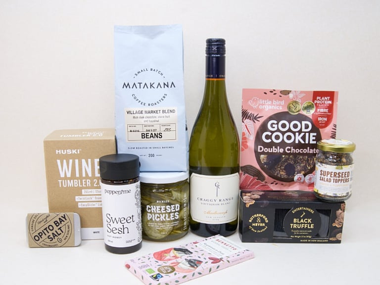 Corporate Gift Hamper featuring Craffy Range Sauvignon Blanc, Matakana Coffee Roasters coffee beans, a HUSKI wine tumbler, Opito Bay salt tin, Bennetto chocolate, PICKLED Sizzled Cucumbers, Rutherford & Meyer Black Truffle Wafer Crackers, a Little Bird Good Cookie, and a Superseed Salad Topper, thoughtfully curated for corporate gifting, client gifts, and settlement gifts.