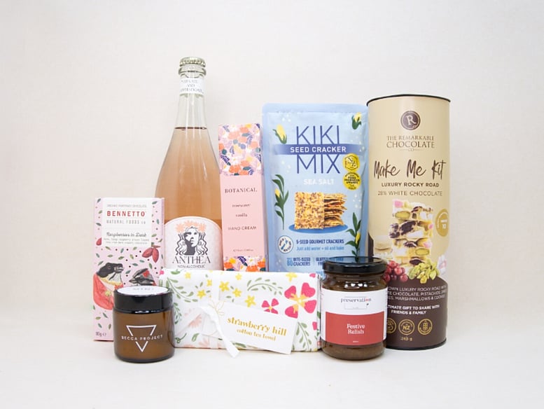 The KYND Gesture Gift Box featuring Anthea alcohol-free spritz, Bennetto chocolate, Stella candle, Botanicals hand cream, gourmet crackers and NZ-made treats.