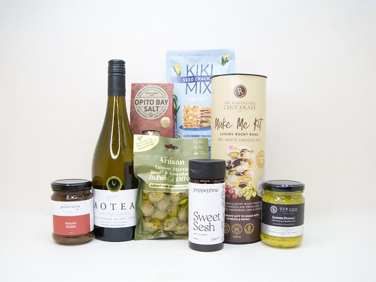 Food & Wine Hamper featuring Aotea Sauvignon Blanc, artisan olives with lemon myrtle and kawakawa, Kiki Seed Crackers, The Kitchen Window Piccalilli, Preservation Festive Chutney, Pepper & Me Hot Honey, Opito Bay Chilli Salt, and a Remarkables Rocky Road Kit, thoughtfully curated for entertaining, grazing, and gourmet gifting.