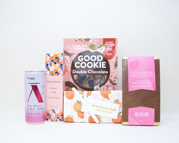 Pretty in Pink gift box with Nectar drink, Elta Ego products, Molly Woppy treats, Strawberry Hill tea towel, coconut ice, chocolate fish, and Bennetto chocolate, presented in a premium gift box