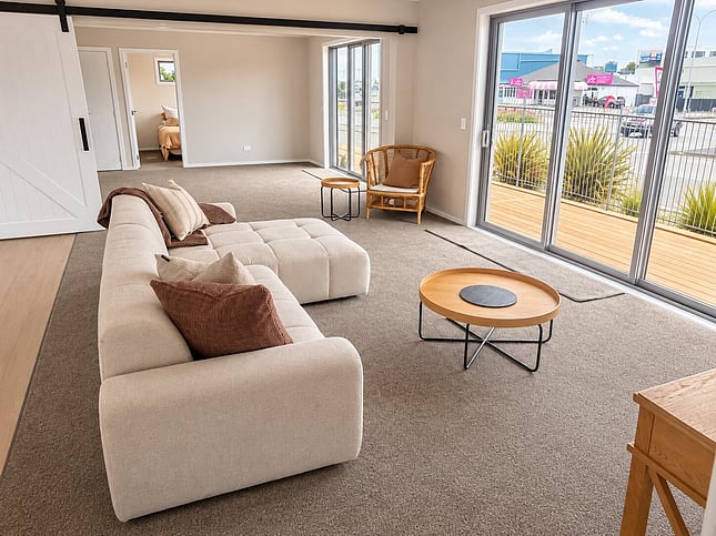 Open-plan living room with sliding doors onto the deck