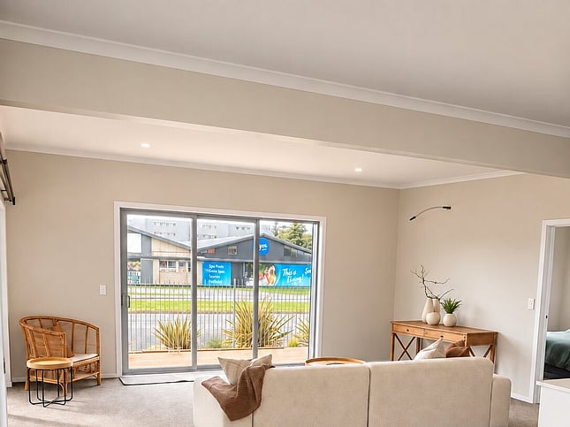 Lounge with sofa and sliding doors to the front garden