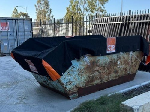 Skip bin cover fitted on a skip bin at a construction site