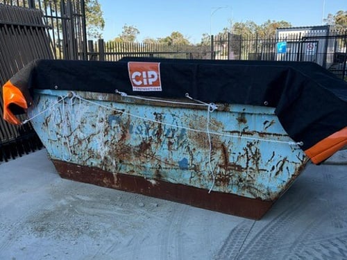 Close view of a skip bin cover's tie rope and eyelet fastening