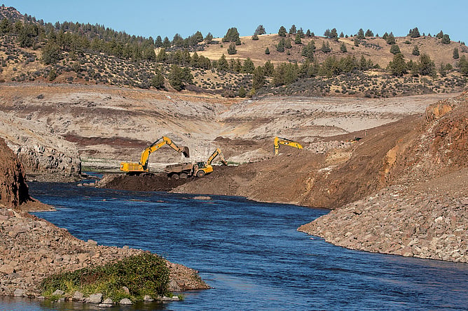Diggers rebuild the banks of the Klamath River in California, to restore natural flow of the river following the removal of a dam.