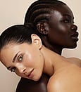 An image of a lady smiling with her eyes shut and face peel cream on her face during a Ultraceutical peel treatment