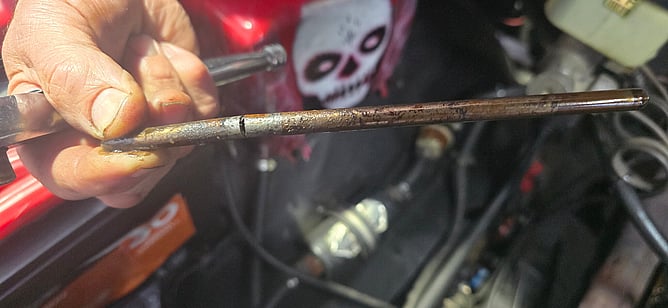 Close view of a bent pushrod with a visible break