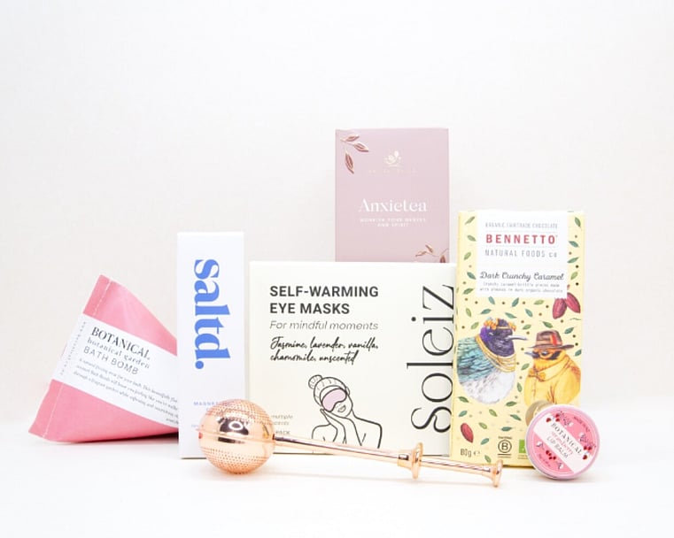 Take It Easy Gift Box featuring Better Tea Co Anxietea tea leaves, tea infuser strainer, Be Good protein bar, Whittaker's Sante bars, and Pure Delish chocolate, beautifully packaged as a calming self-care and wellness gift.