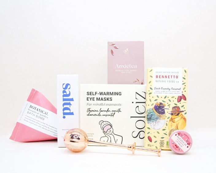 Take It Easy Gift Box featuring Better Tea Co Anxietea tea leaves, tea infuser strainer, Be Good protein bar, Whittaker's Sante bars, and Pure Delish chocolate, beautifully packaged as a calming self-care and wellness gift.
