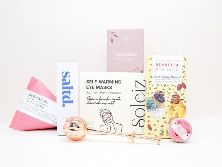 Take It Easy Gift Box featuring Better Tea Co Anxietea tea leaves, tea infuser strainer, Be Good protein bar, Whittaker's Sante bars, and Pure Delish chocolate, beautifully packaged as a calming self-care and wellness gift.