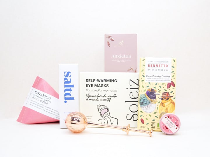 Take It Easy Gift Box featuring Better Tea Co Anxietea tea leaves, tea infuser strainer, Be Good protein bar, Whittaker's Sante bars, and Pure Delish chocolate, beautifully packaged as a calming self-care and wellness gift.