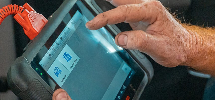 Diagnostic scanner being used in a vehicle