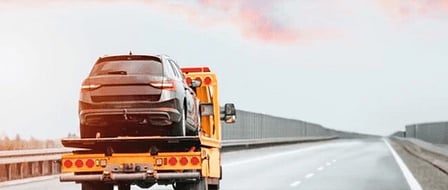 Vehicle being transported on a recovery truck