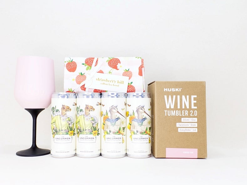 Pretty Wine Gift Box with four Uncommon wine cans, a HUSKI wine cooler, and a Strawberry Hill tea towel, thoughtfully presented in a premium gift box for relaxing, celebrating, and enjoying life's little moments