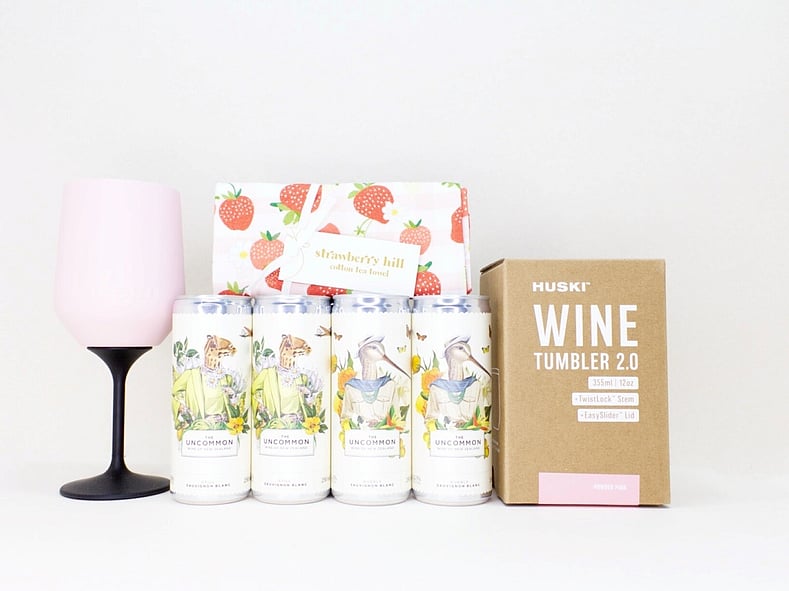 Pretty Wine Gift Box with four Uncommon wine cans, a HUSKI wine cooler, and a Strawberry Hill tea towel, thoughtfully presented in a premium gift box for relaxing, celebrating, and enjoying life's little moments