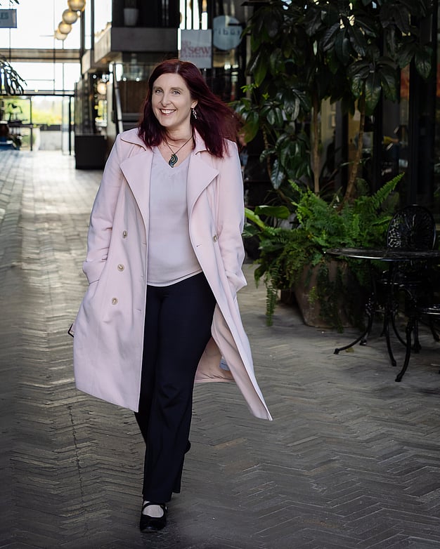 Brand portrait of Karin Vincent from Tea & Happiness Rotorua in front of her tiny home