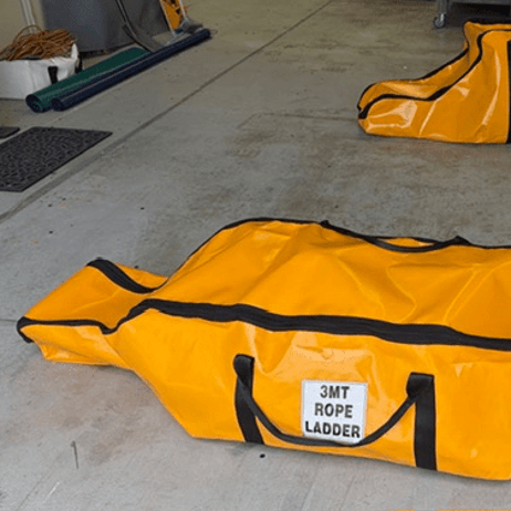 Two orange rope ladder bags in different sizes on a workshop floor