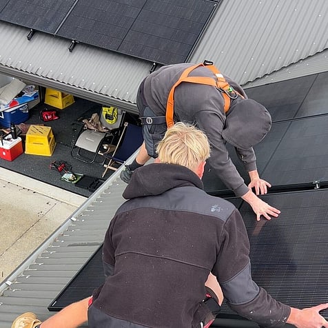Our crew fitting panels on a roof in Te Awamutu